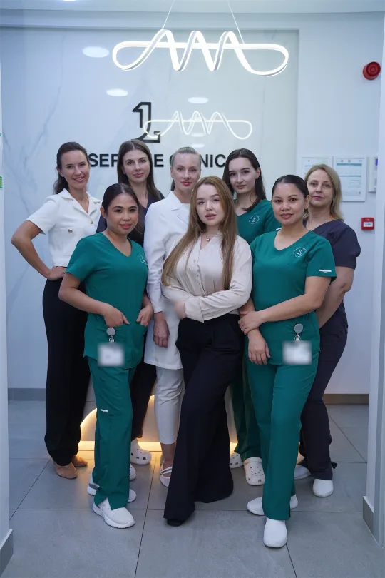 The Laser One team in front of the clinic's neon logo